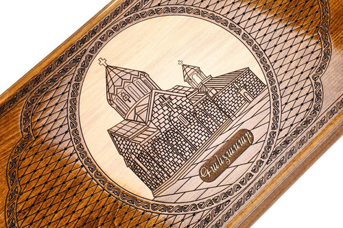 Gandzasar Monastery engraved in pale inlaid wood inside a scalloped oval
