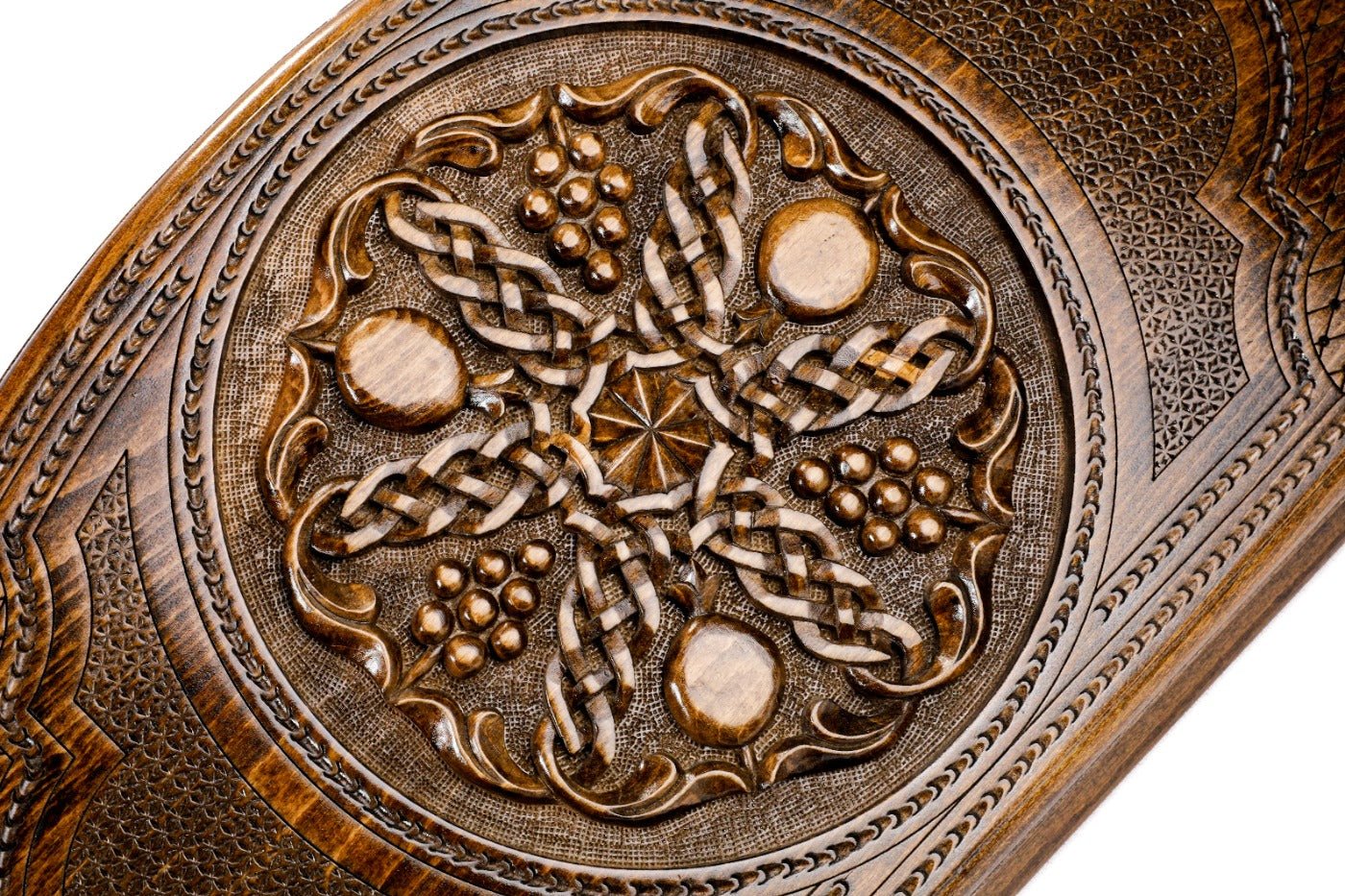 Frontal view of the intricate grapevine and pomegranate relief on the solid wood exterior.