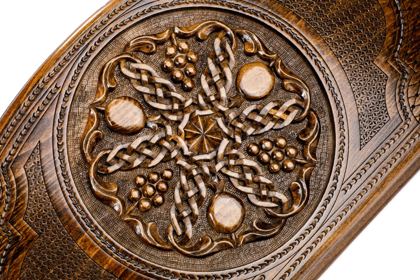 Frontal view of the intricate grapevine and pomegranate relief on the solid wood exterior.