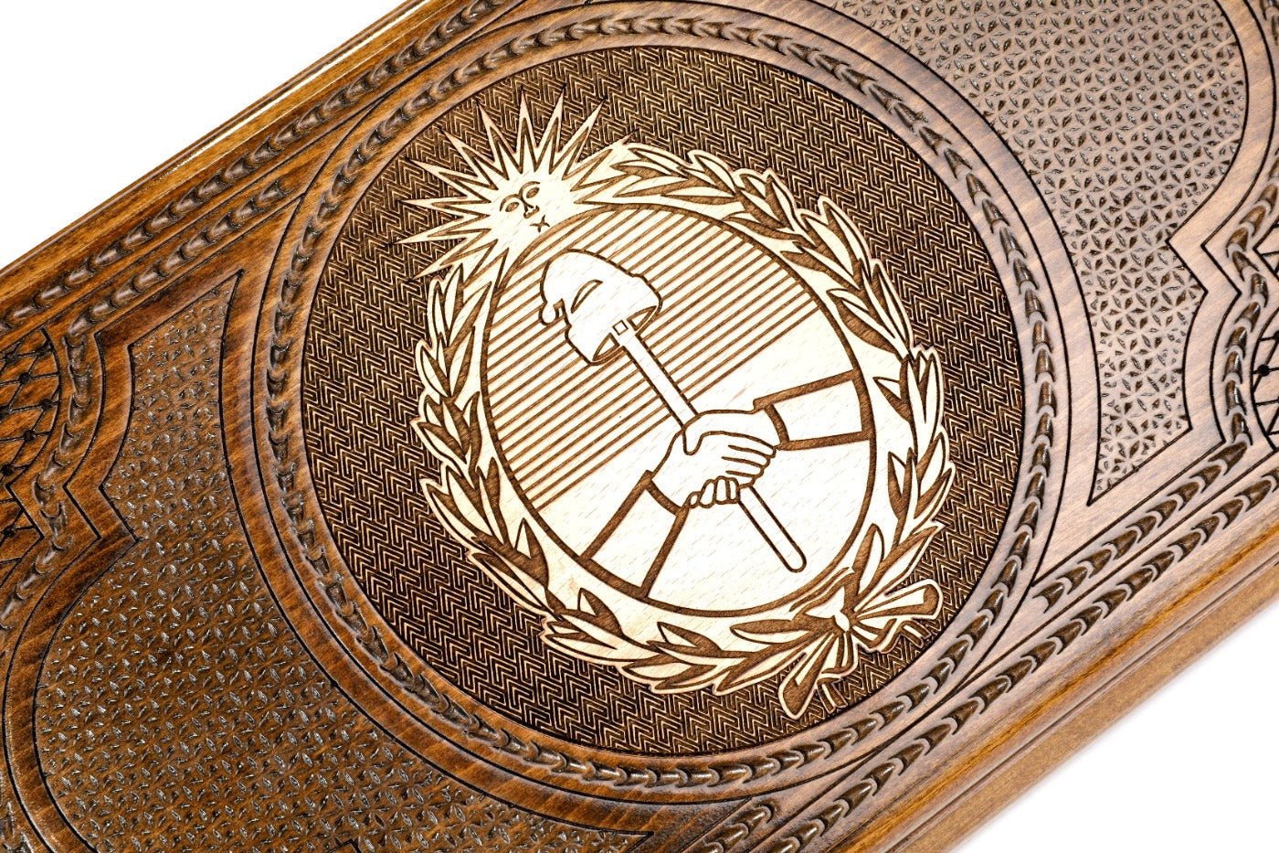 Frontal view of the hand-carved Argentine crest on the solid wood exterior.