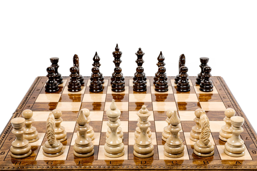 Chessboard with black and white chess pieces on a white background