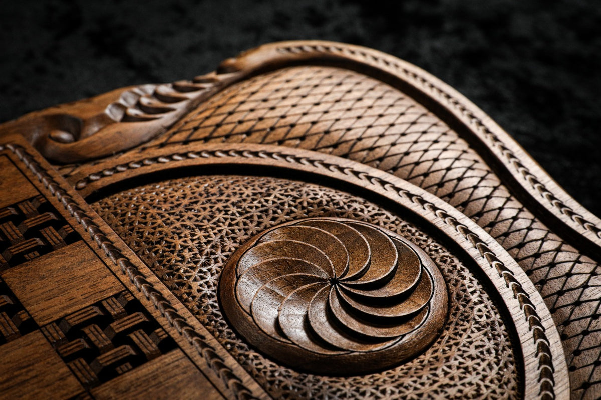 Close-up of the eternity whirl in deep relief on its lattice ground, rope border beside it