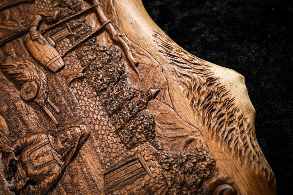 Butter churn hanging from the tree beside the orchard, carved in deep relief, close-up