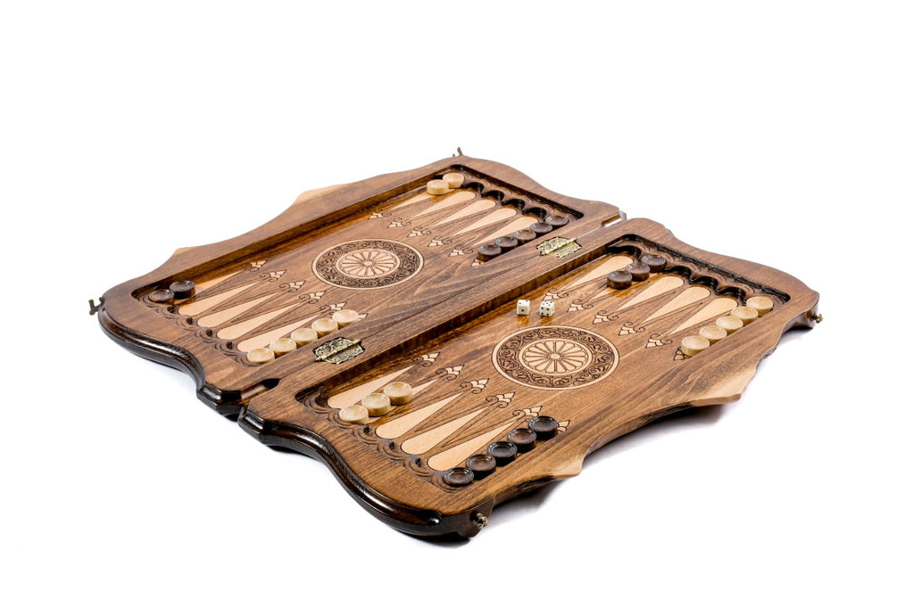 A side-angle macro shot focusing on the depth of the wood engravings and the sturdy metal hinges of the folding board.