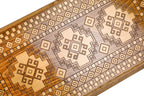 Frontal view of the traditional rug motif relief on the solid wood exterior.