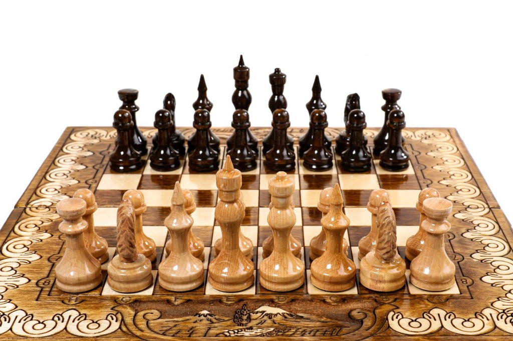 Small handcrafted chess set with ornamental pattern and integrated backgammon board