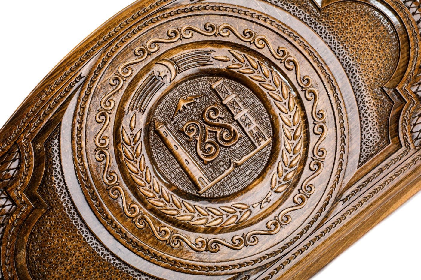 Detail view of the hand-carved Chechen national emblem on the solid wood exterior.