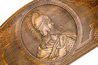 Detail view of the hand-carved commander relief on the solid wood exterior.