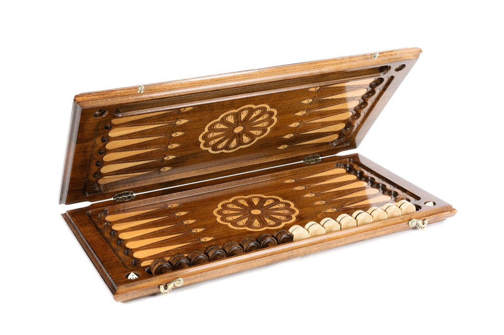 Backgammon board half open showing the dark field, pale fleur-de-lys points and wheel ornaments
