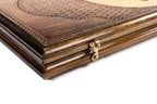 Edge of the closed backgammon board with the bronze clasp and the layered lattice lid