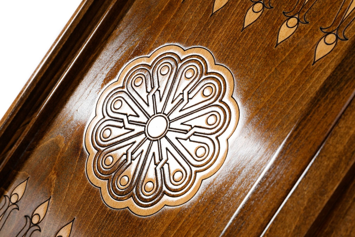 Eight-petal wheel ornament cut into the dark field of the open backgammon board