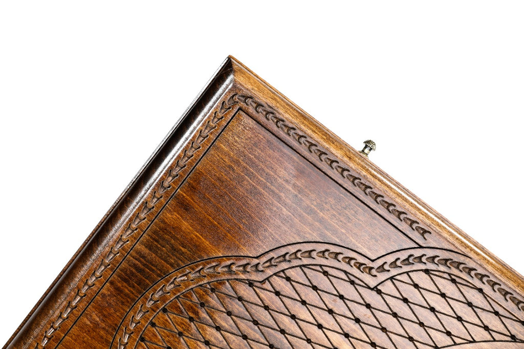 Corner of the lid: faceted lattice, rope border and lobed cartouche on the classic outline board