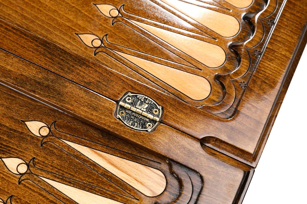 Stamped bronze hinge on the centre bar of the open board, pale fleur-de-lys points beside it