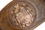 Frontal view of the hand-carved Georgian national emblem on solid wood.