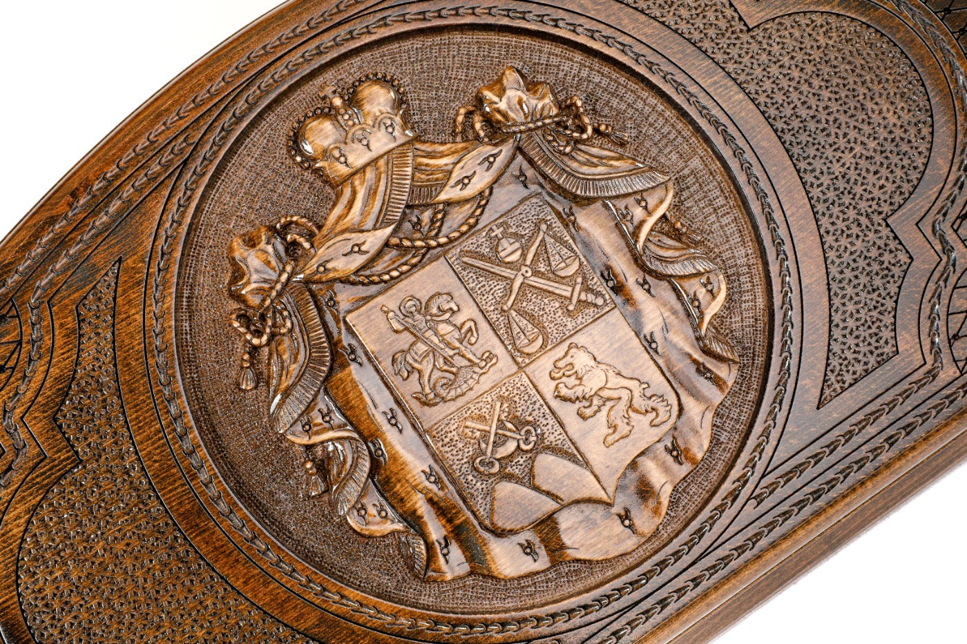 Frontal view of the hand-carved Georgian national emblem on solid wood.