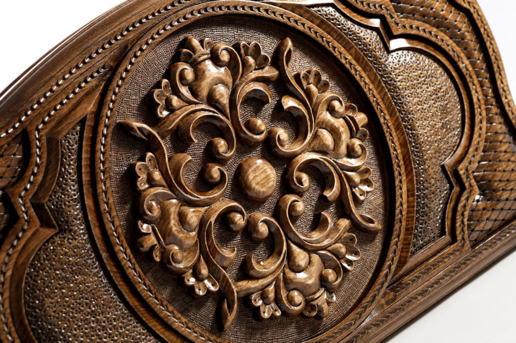 Frontal view of the detailed floral ornamental relief on the solid wood exterior.