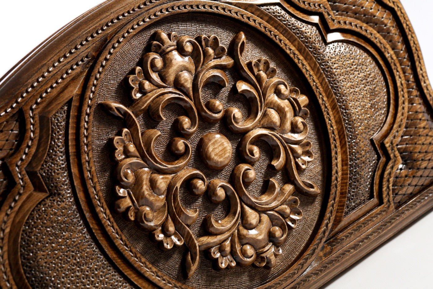 Frontal view of the detailed floral ornamental relief on the solid wood exterior.