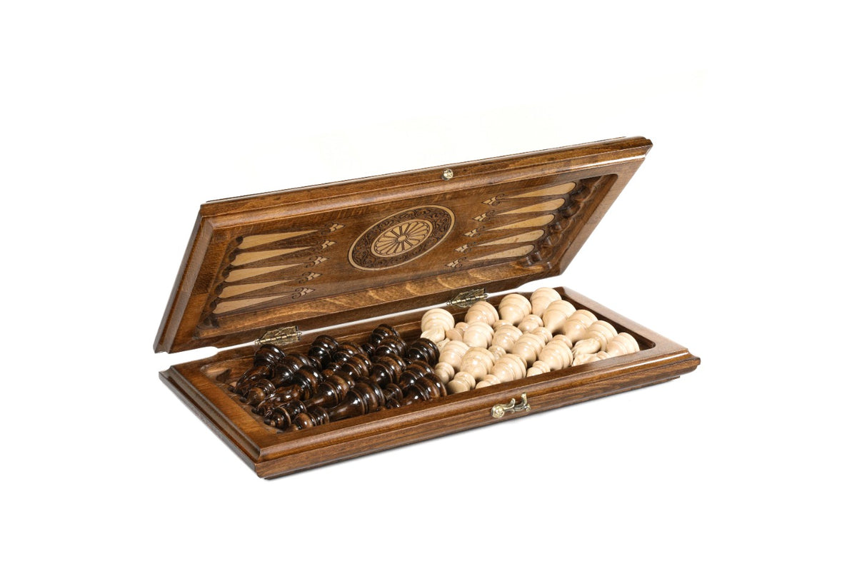 Chess backgammon set half open with the hand-carved pieces stored on the backgammon field