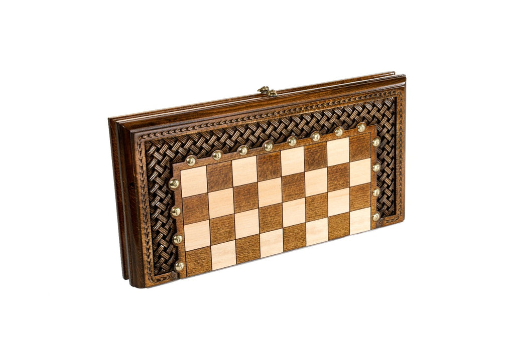 Closed wooden chess and backgammon board with woven braid ornament carved around the squares