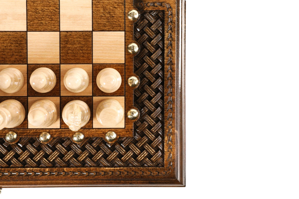 Corner detail of the deep-carved braid ornament and bronze coordinate studs with light pieces