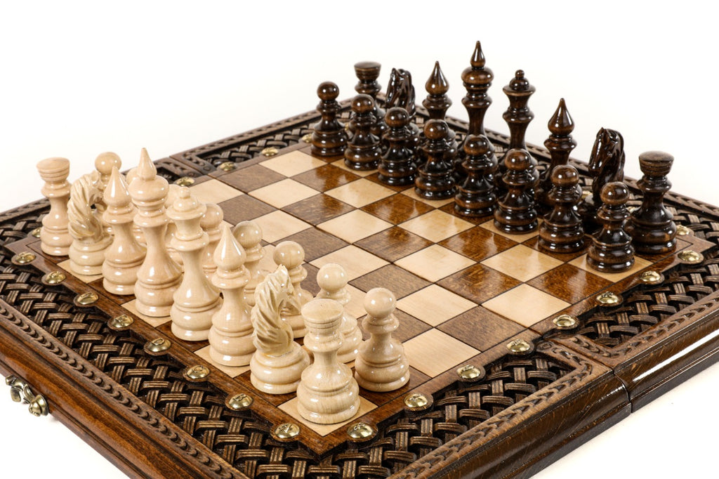 Hand-carved braid ornament border of the wooden chess board with carved pieces, close angle