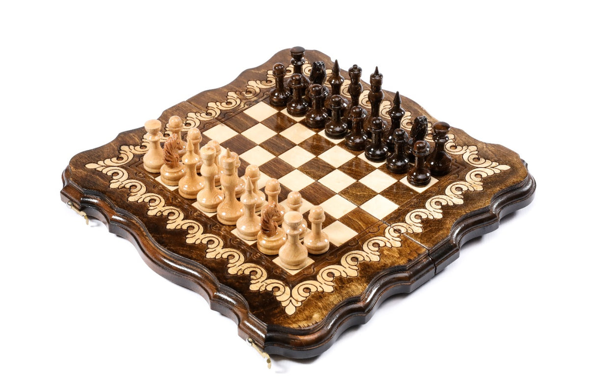 Travel wooden chess and backgammon set with scalloped contour outline and light-wood scroll ornament, pieces set for play