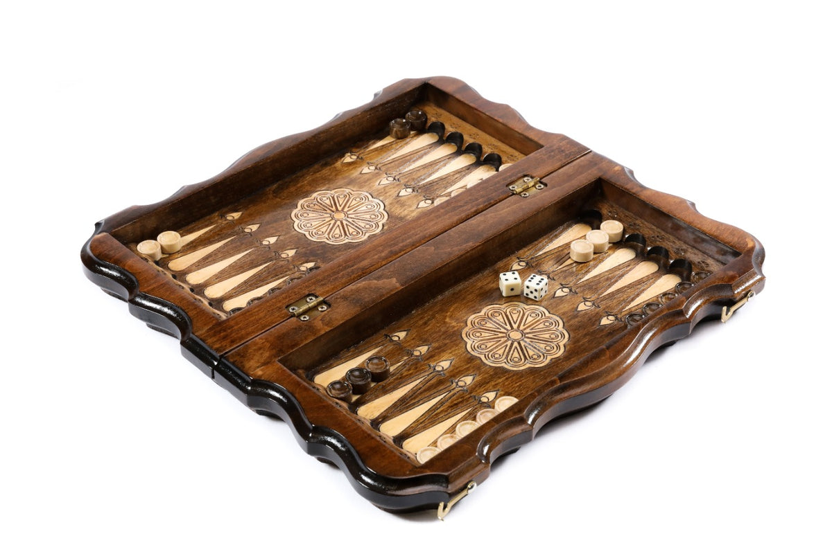 Portable chess backgammon set opened to the two-tone backgammon field with flower ornaments and dice