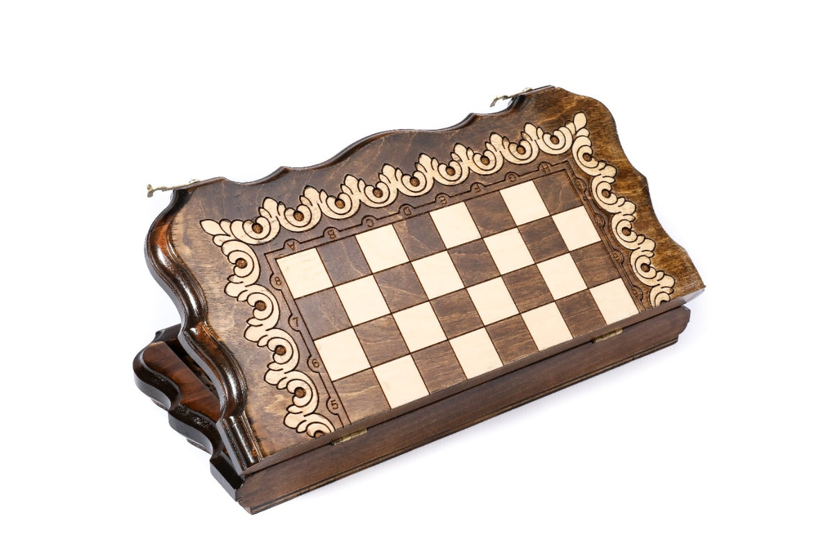 Closed wooden chess and backgammon board with scalloped edge and pale scroll ornament