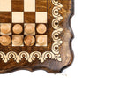 Corner detail of the scroll ornament border and light wooden chess pieces