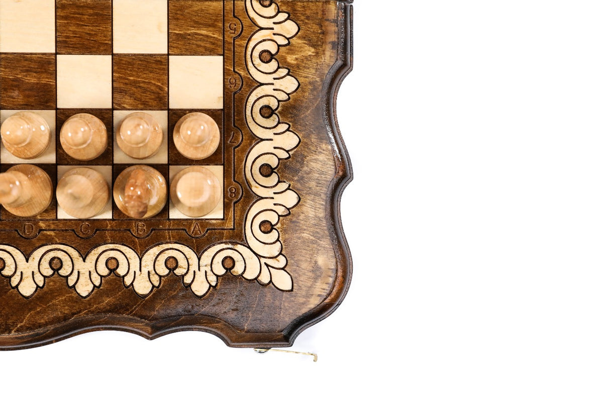 Corner detail of the scroll ornament border and light wooden chess pieces