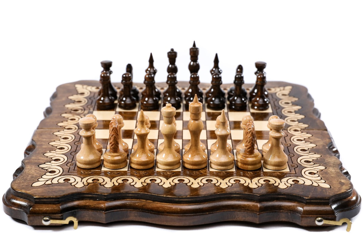 Front view of the travel chess set with all 32 pieces in starting position on the ornamented board