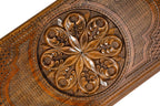 Frontal view of the detailed floral ornamental relief on the solid wood exterior.