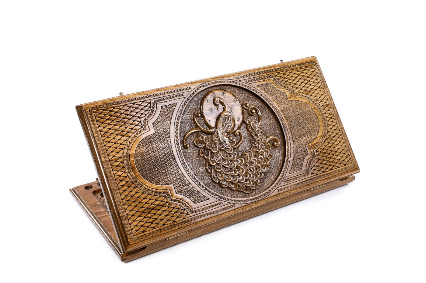 A frontal shot of the closed Peacock classic backgammon board showing the detailed high-relief feather carvings.