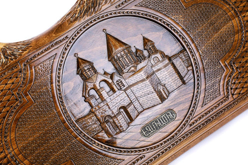 Close-up of the hand-carved Etchmiadzin Cathedral, bell tower and walls in deep relief with the Armenian name plaque
