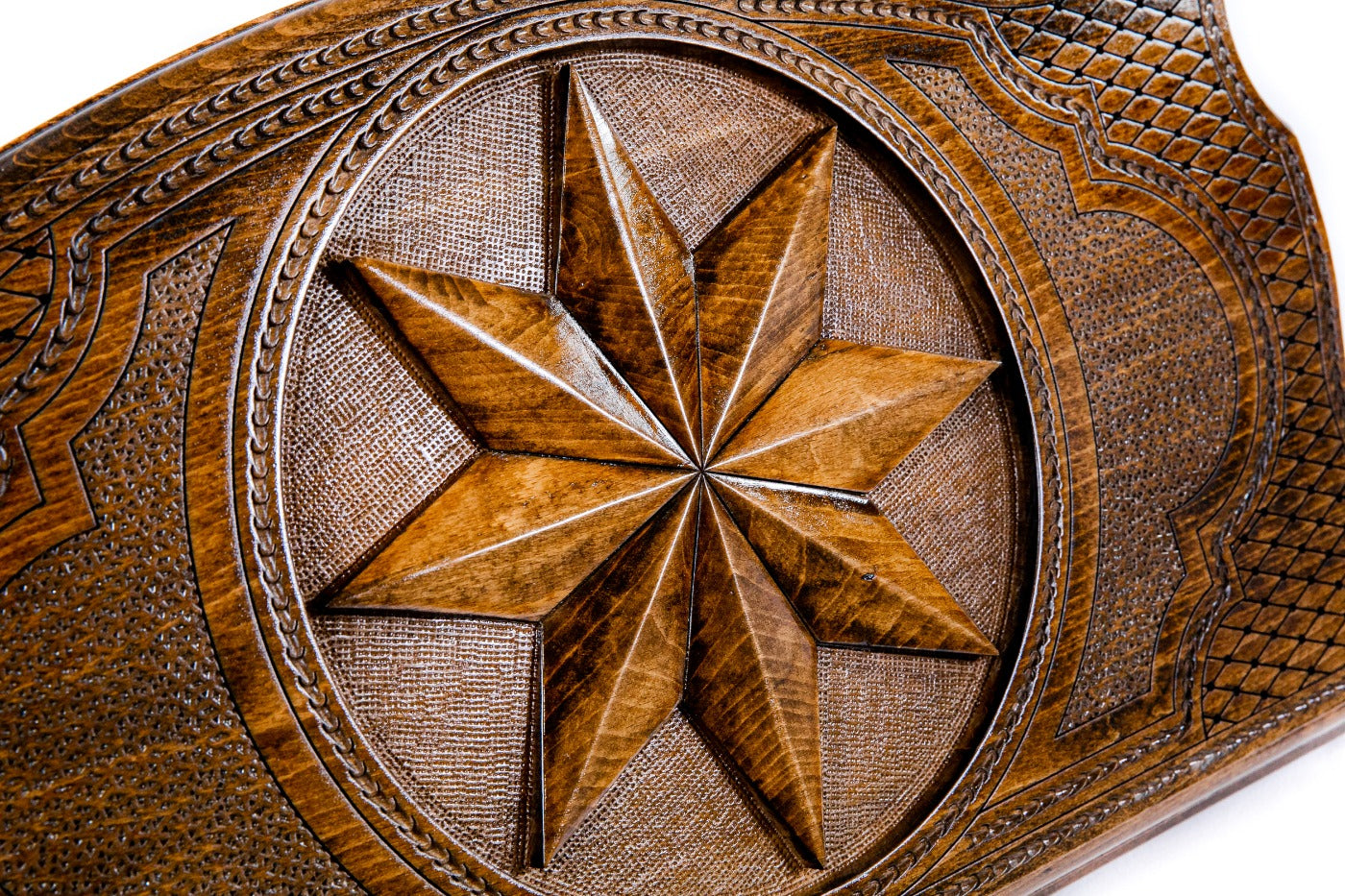 The reverse side of the board showing the hand-carved checkers and chess grid on the solid wood surface.