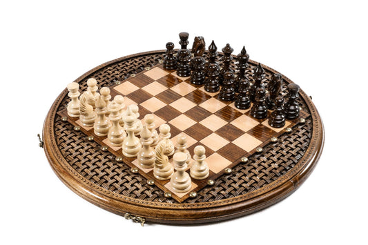 round carved wooden chess set with ornamental pattern and bronze details