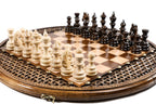 circular chess board with carved design and bronze accents