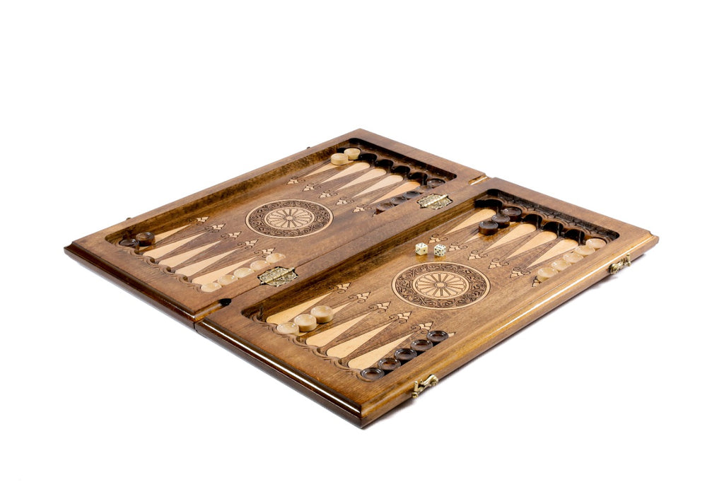 Chess and backgammon set opened to the carved backgammon field with a wheel ornament in each half