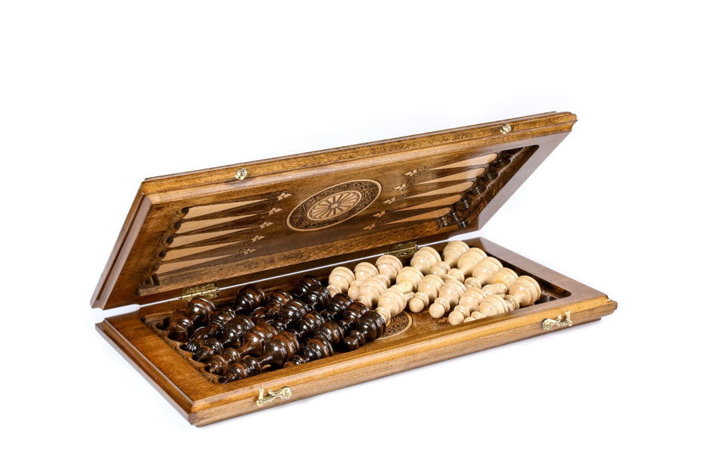 Chess backgammon set open with wooden checkers on the carved backgammon points