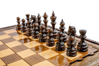 Dark hand-carved chess pieces on the beech and walnut checkered board