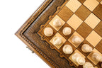 Close view of light chess pieces and the carved ornament border of the chess board