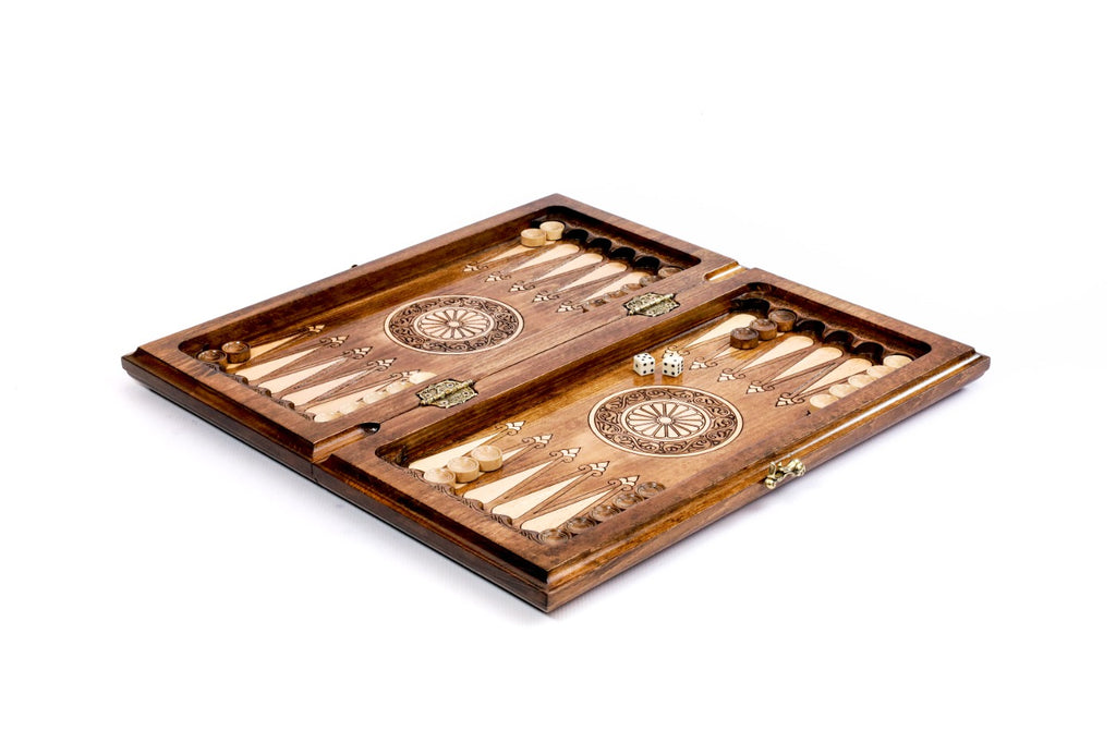 Ararat chess backgammon set opened to the carved backgammon field with wheel ornaments and checkers