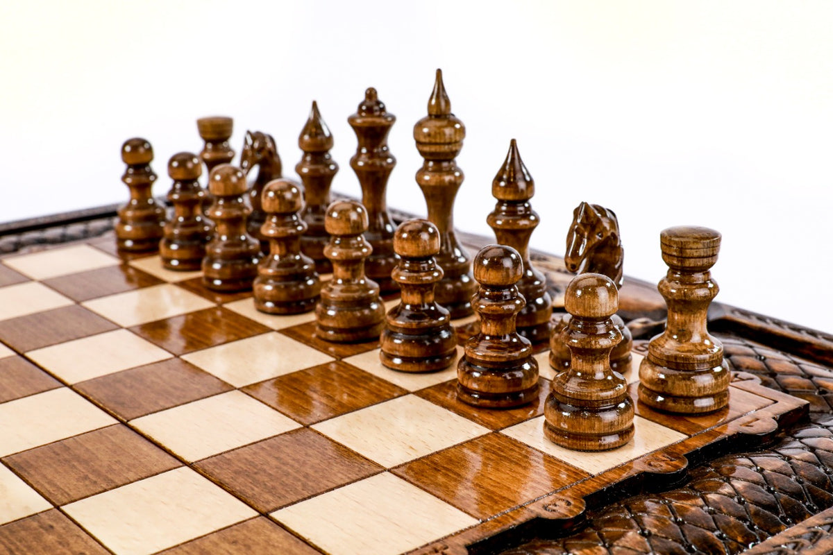 Dark hand-carved chess pieces on the beech and walnut squares of the Ararat chess board