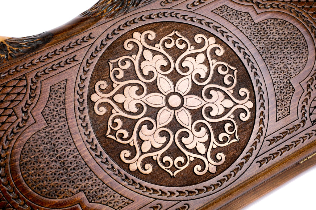 The interior of the open Armenian backgammon set showing the rich wood textures and the smooth, contrasting triangular points.
