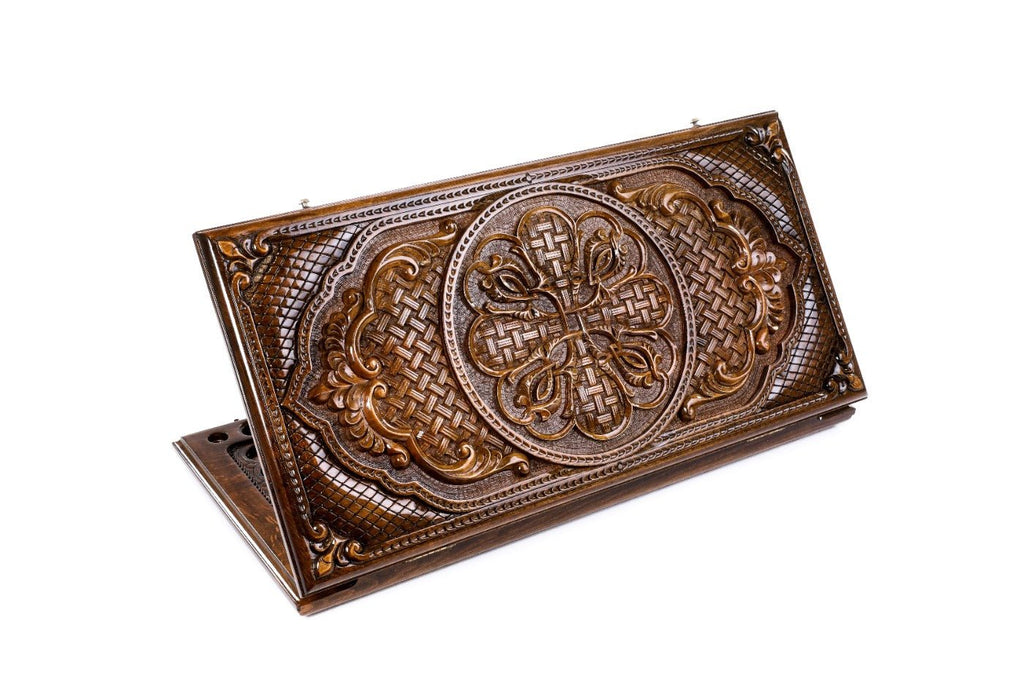 A frontal shot of the closed Ornamental Bas-Relief backgammon board showing the symmetrical interlacing wood carvings.