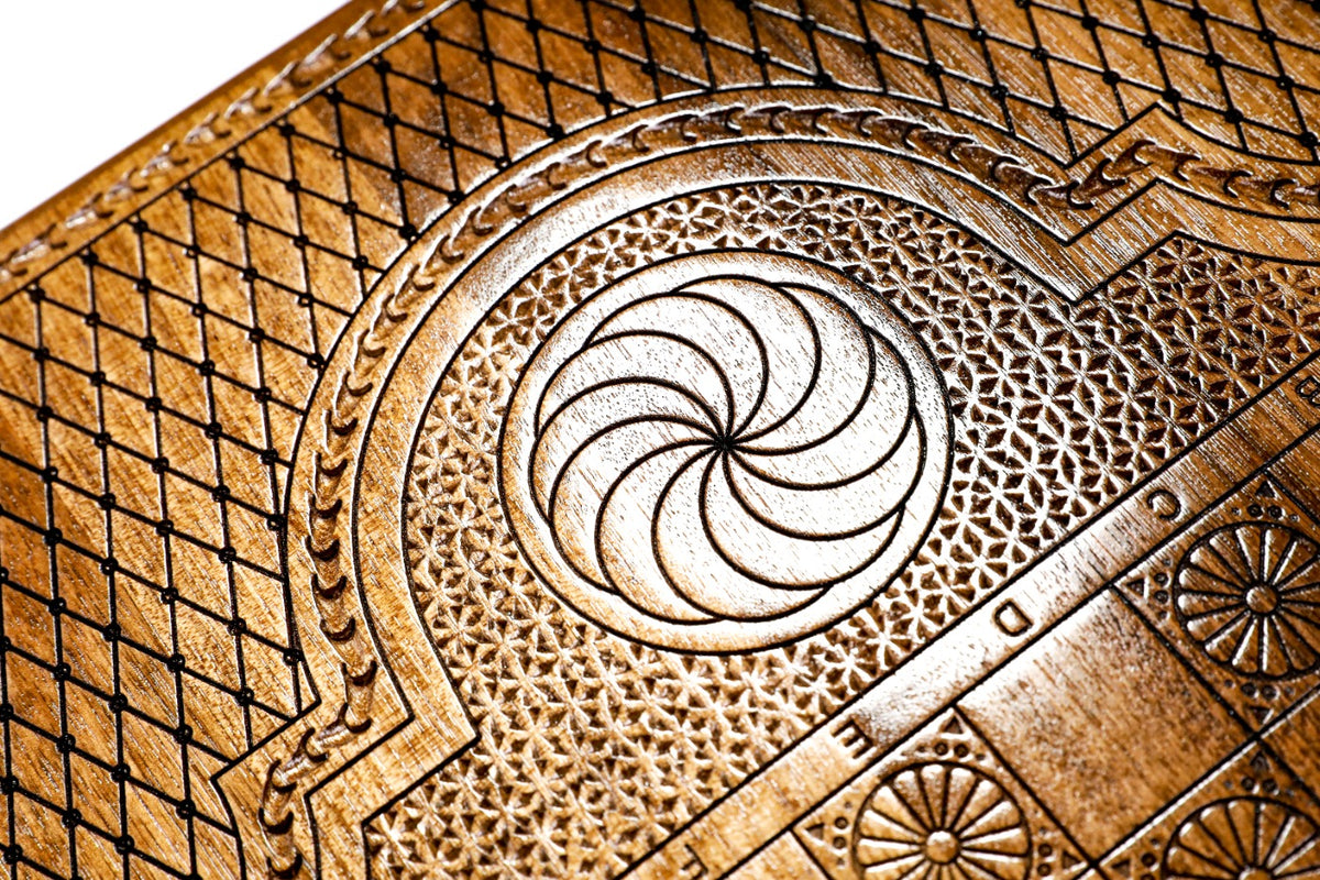 Eternity whirl carved in the lattice cartouche beside the chequerboard on the back cover