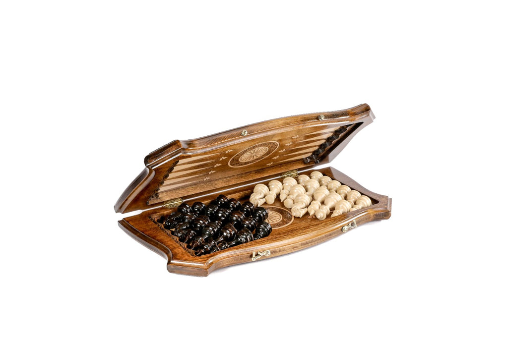 Chess backgammon set half open with the hand-carved pieces stored on the backgammon field