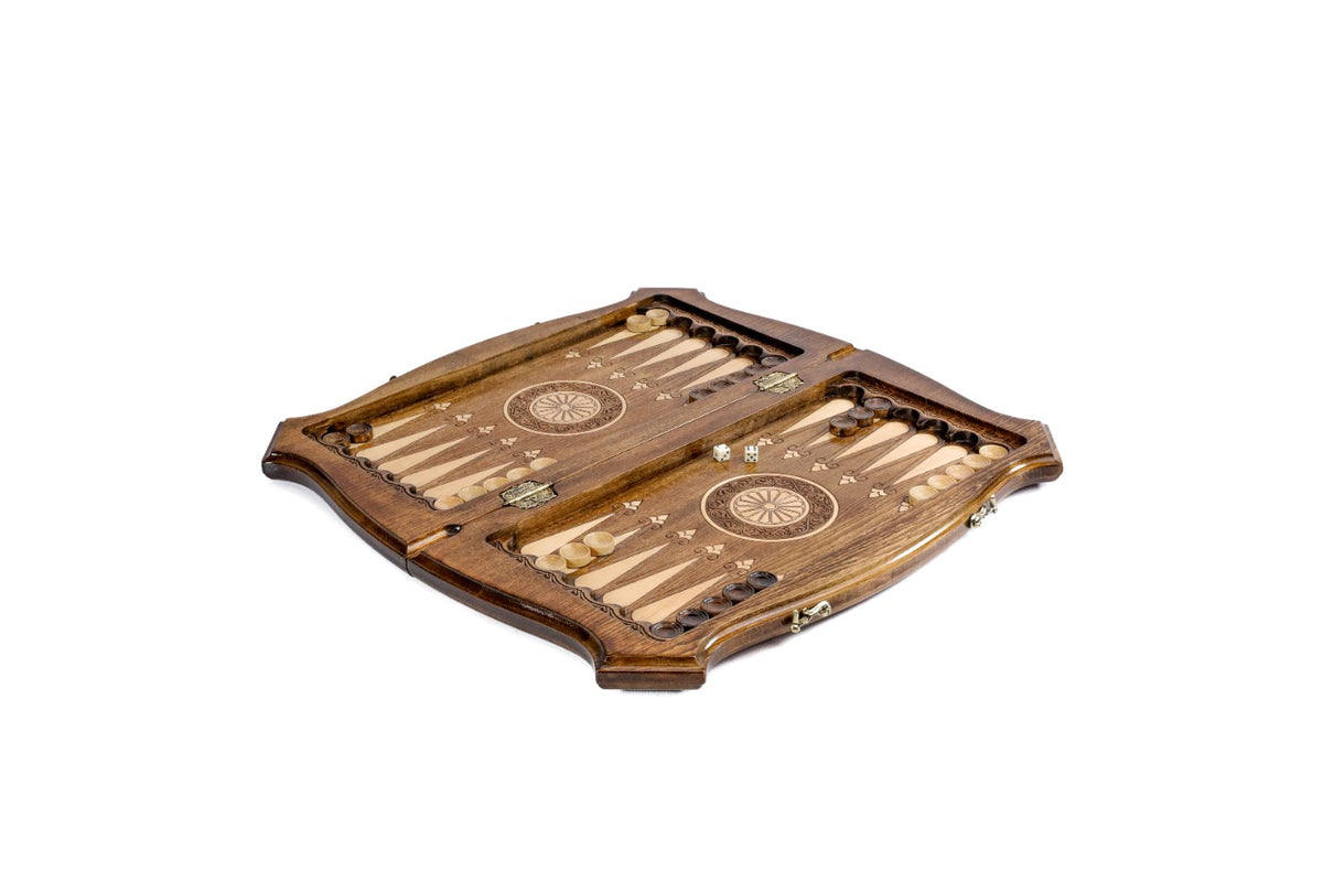 Contour chess and backgammon set opened to the carved backgammon field with wheel ornaments and checkers