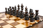 Dark hand-carved chess pieces on the beech and walnut squares of the contour board