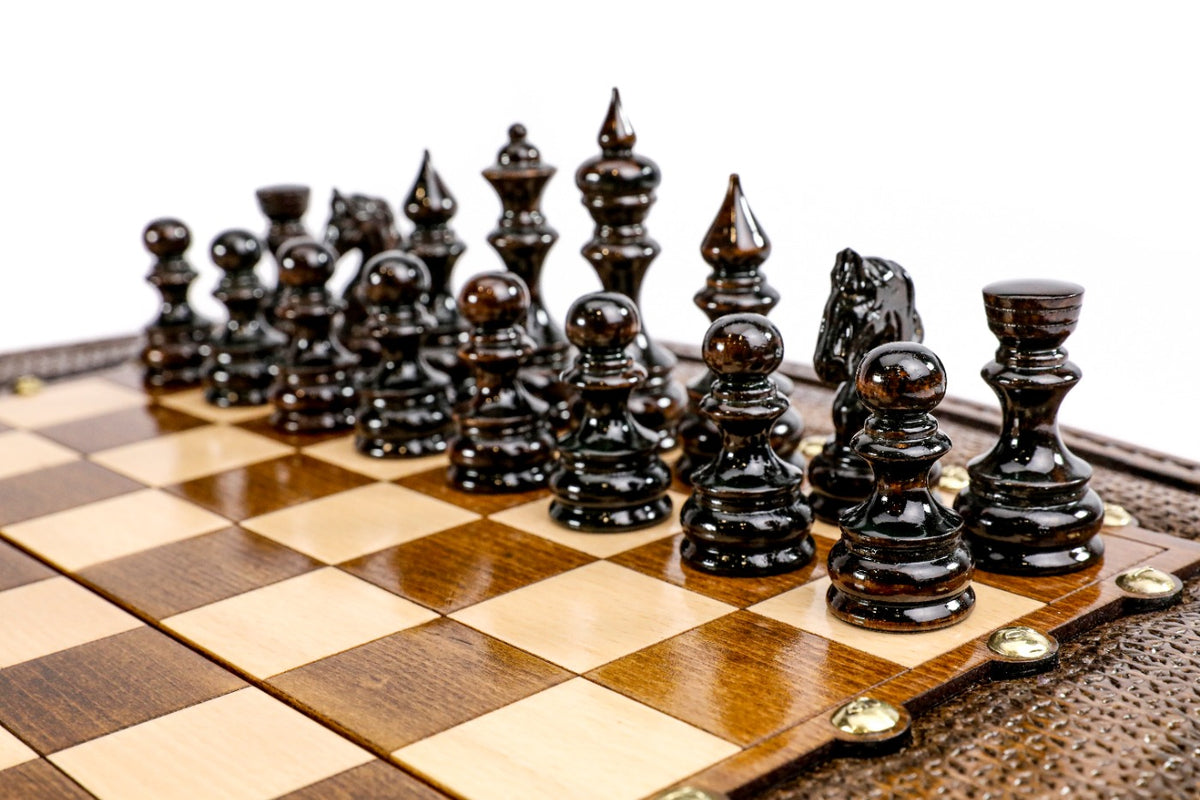 Dark hand-carved chess pieces on the beech and walnut squares of the contour board